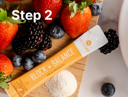 Lifestyle shot of the NeoraFit Block + Balance pre & probiotic sachet on a wooden board surrounded by various berries.